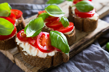 Bruschetta with cream cheese cherry tomatoes and basil