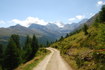 Fototapeta na wymiar Mountain road panoramic view Swiss alps