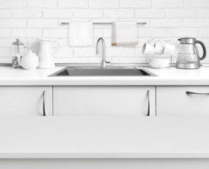White laminated table on blurred rustic kitchen sink interior background