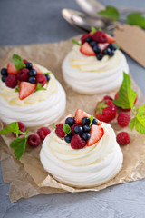 Pavlova cakes with cream and fresh berries