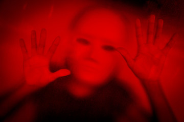 Woman wearing white mask behind stained or dirty window glass,Scary background for book cover