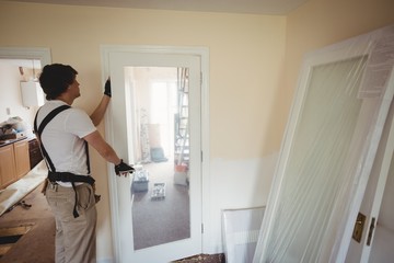 Carpenter fixing a door