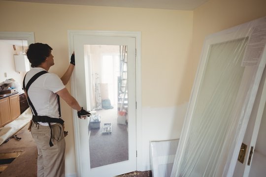 Carpenter fixing a door