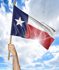 Person's hand holding the Texas state flag and waving it in the sky, part 3D rendering