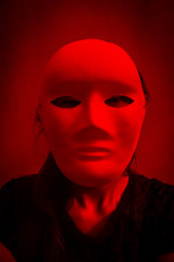 Mysterious woman in black dress wearing white mask,Scary background for halloween