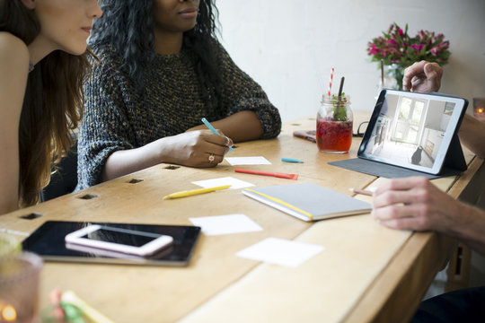Young business people having meeting in a cafe