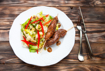Hot teriyaki chicken with vegetables salad  on dark wooden backg