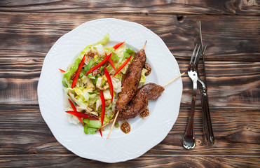 Hot teriyaki chicken with vegetables salad  on dark wooden backg
