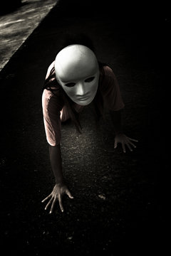 Mysterious Woman Wearing White Mask Crawling On The Floor,Scary Background For Halloween