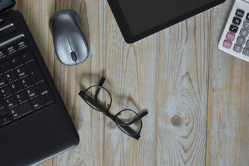 Close up of a wooden table bureau at the office with laptop, computer, mouse, fontain pen  and...