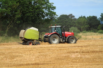 Fototapeta na wymiar red tractor and green trailer