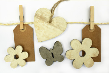 white wash heartshape, flower, butterfly  hand made of wood on a white wooden background with empty copy space
