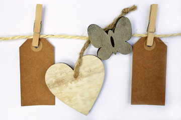 white wash heartshape, flower, butterfly  hand made of wood on a white wooden background with empty copy space
