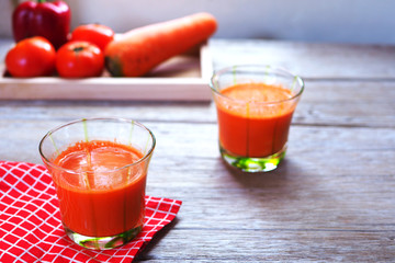 A glass of healthy mixed juice of carrot, tomato and capsicum 