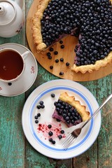 Open homemade pie with fresh forest blueberries