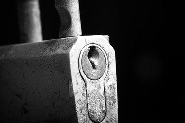 Old metal lock on a black background. Selective focus. Shallow d