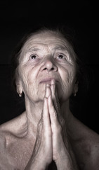 Portrait of elderly woman. Prayer. Toned