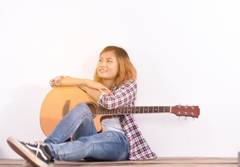 Woman play with guitar at home