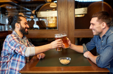 happy male friends drinking beer at bar or pub