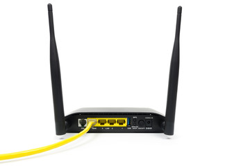 Yellow Cable connected to a wireless router modem isolated on wh