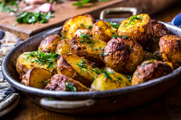 Potato. Roasted potatoes. American potatoes with smoked bacon garlic salt pepper cumin dill parsley - herb decoration.
