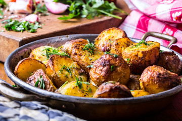 Potato. Roasted potatoes. American potatoes with smoked bacon garlic salt pepper cumin dill parsley - herb decoration.