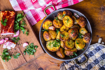 Potato. Roasted potatoes. American potatoes with smoked bacon garlic salt pepper cumin dill parsley - herb decoration.