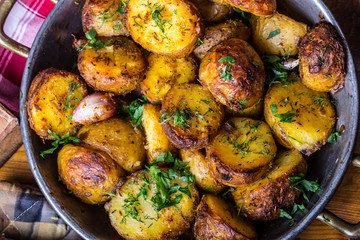 Potato. Roasted potatoes. American potatoes with smoked bacon garlic salt pepper cumin dill parsley - herb decoration.