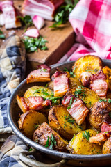 Potato. Roasted potatoes. American potatoes with smoked bacon garlic salt pepper cumin dill parsley - herb decoration.