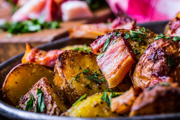 Potato. Roasted potatoes. American potatoes with smoked bacon garlic salt pepper cumin dill parsley - herb decoration.