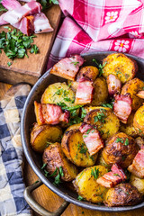 Potato. Roasted potatoes. American potatoes with smoked bacon garlic salt pepper cumin dill parsley - herb decoration.