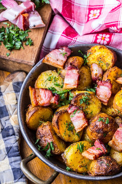 Potato. Roasted potatoes. American potatoes with smoked bacon garlic salt pepper cumin dill parsley - herb decoration.