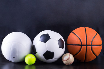 Basket ball, volley ball, football, tennis ball and baseball in black background