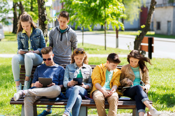 group of students with tablet pc at school yard