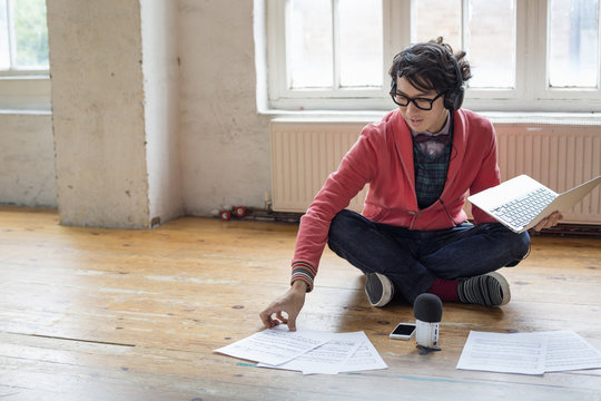 Young man sitting on the floor with laptop