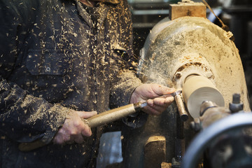 Man using woodworking machine in a carpentry workshop