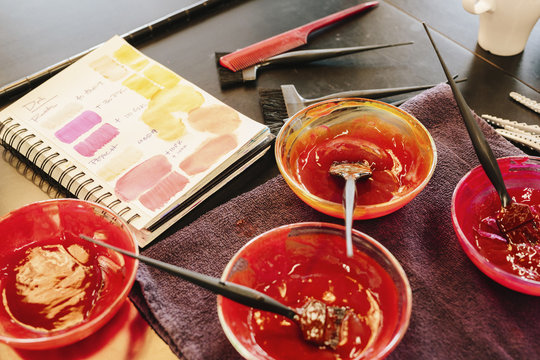 Pots of hair colour and a colour chart in a hair salon.