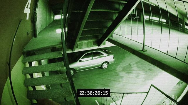 Security camera footage of a car being broken into.