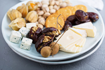 Cheese plate with crackers, dates and nuts