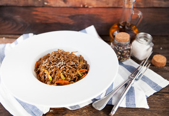 Tasty Soba noodles with vegetables in sweet and sour sauce on ol