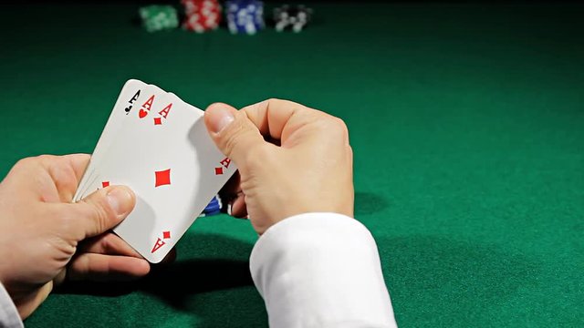 playing poker with aces of  poker hand waiting to bet at the casino'