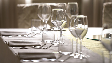 White tablecloth and crystal glasses.