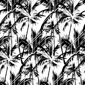 Seamless vector monochrome tropical pattern depicting white palm tree on a black background