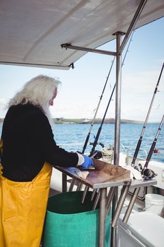 Fisherman filleting fish