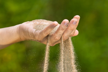 sand running through hand © rodimovpavel