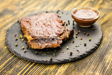 Beef steak on a wooden table.