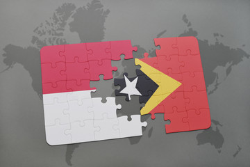 puzzle with the national flag of indonesia and east timor on a world map background.