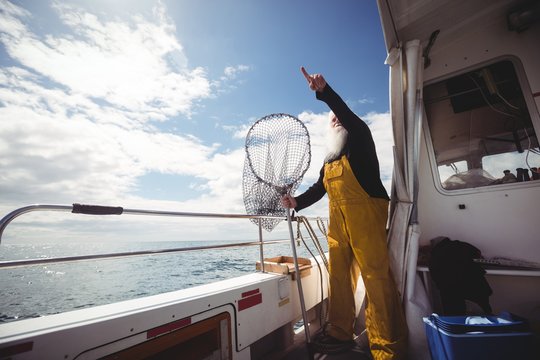 Fisherman pointing at distance