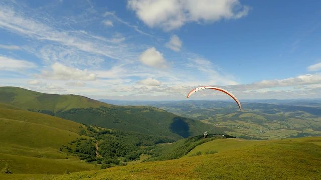 Paraglider taking off from a mountain