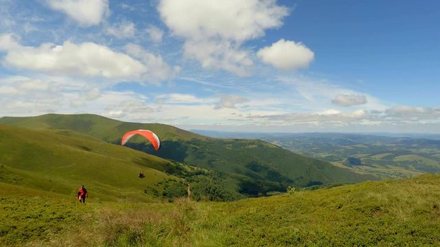 Paraglider taking off from a mountain